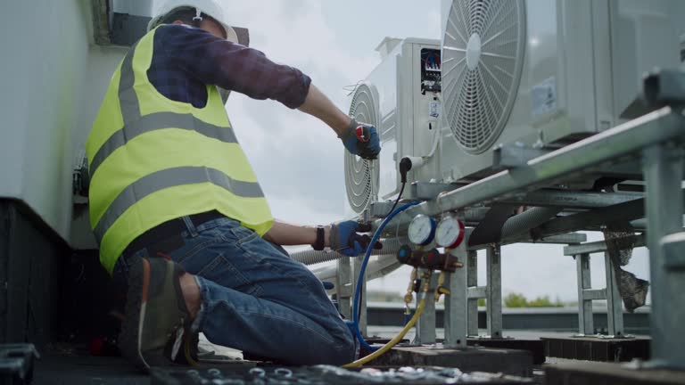 Installation process of an AC unit in a house. Technicians at work preparing the cooling system